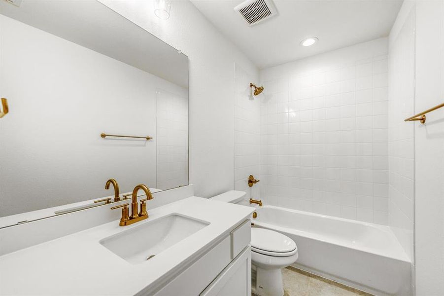 Bathroom featuring vanity, shower / tub combination, recessed lighting, and light tile patterned floors