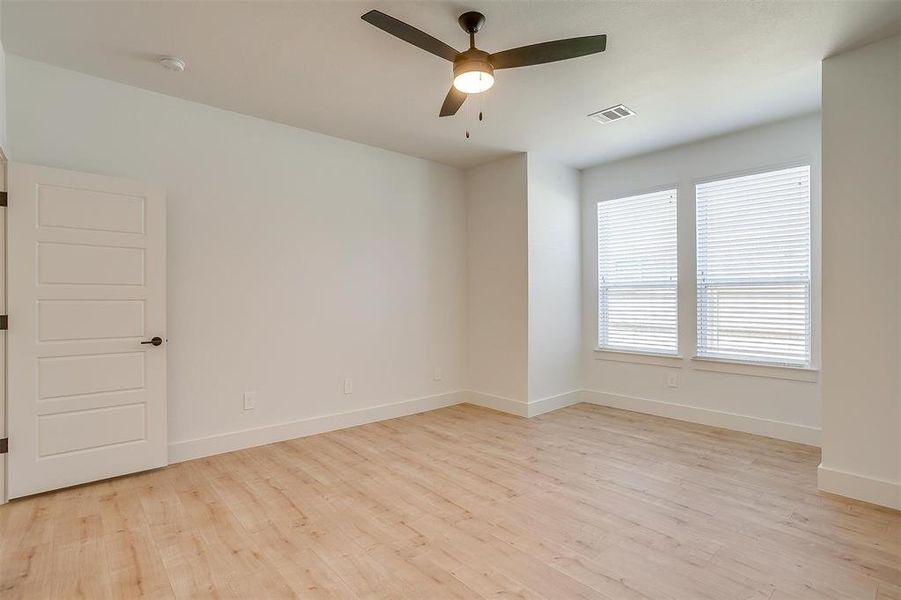 Unfurnished room featuring ceiling fan and light hardwood / wood-style flooring