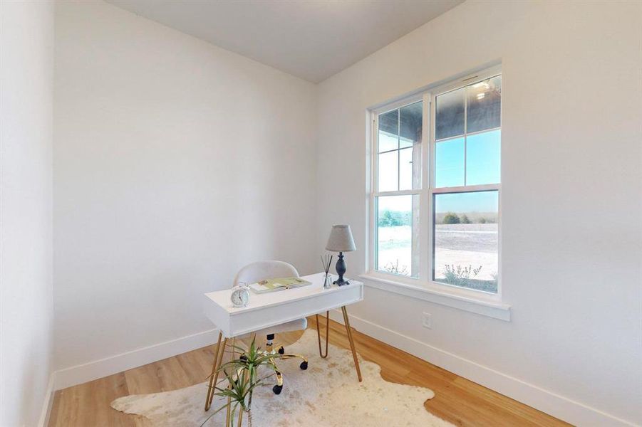 Home office with hardwood / wood-style flooring