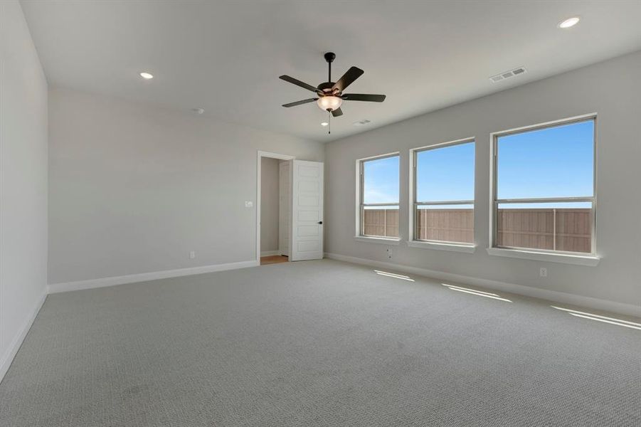 Spare room featuring carpet floors, ceiling fan, and recessed lighting