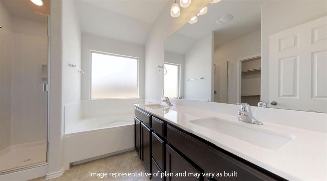 Bathroom with a shower stall, a bath, double vanity, a walk in closet, and light tile patterned floors Bathroom with a shower stall, a bath, double vanity, a walk in closet, and light tile patterned floors