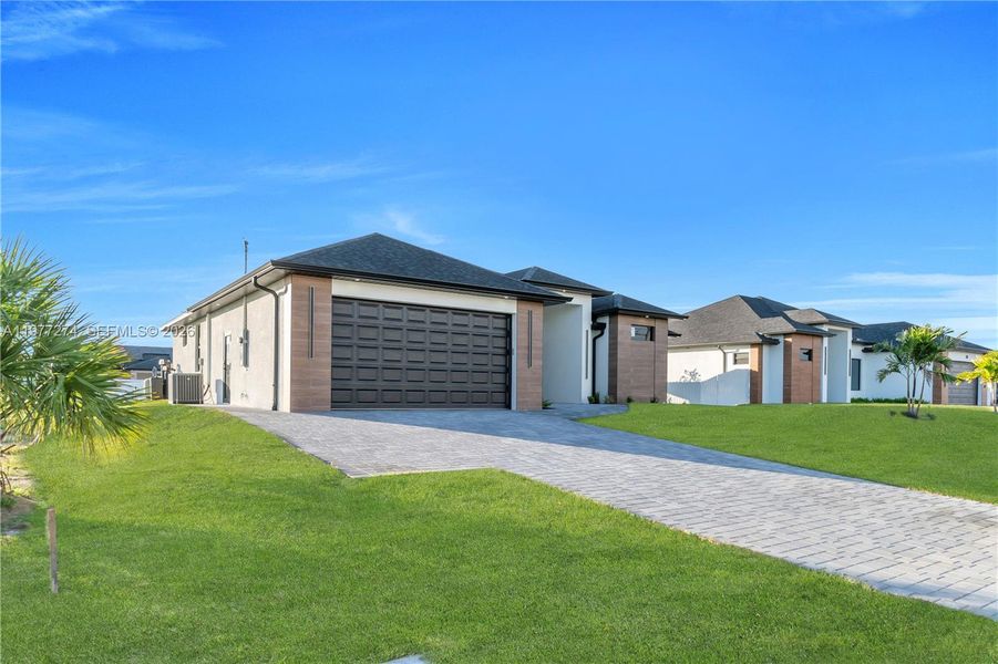 Front exterior of a new home in , Cape Coral, FL, highlighting curb appeal (Image 24).
