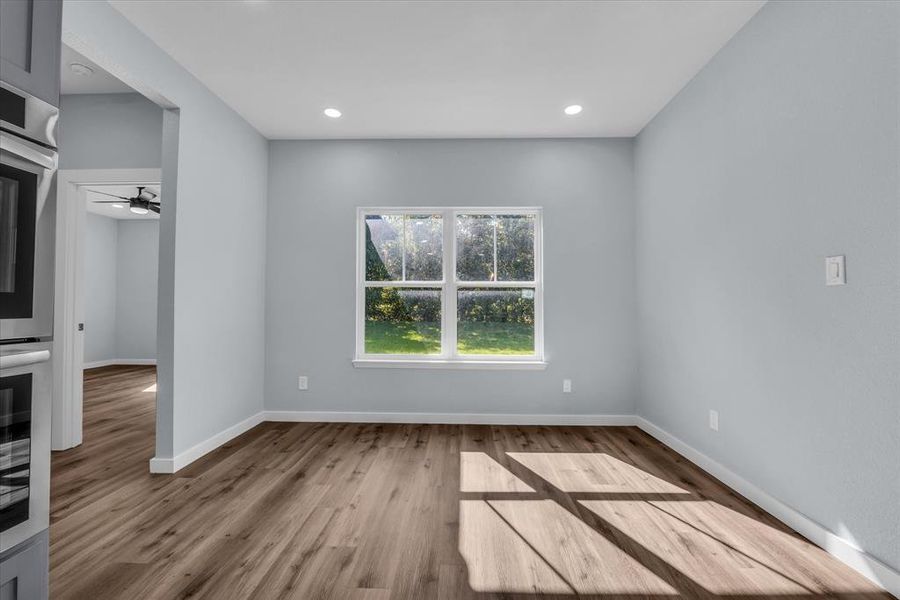 Unfurnished room featuring light wood-style flooring, recessed lighting, and a ceiling fan Unfurnished room featuring light wood-style flooring, recessed lighting, and a ceiling fan