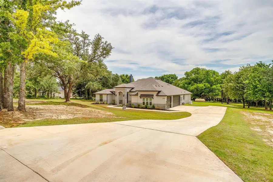 Front exterior of a new home in , Poolville, TX, highlighting curb appeal (Image 21). Front exterior of a new home in , Poolville, TX, highlighting curb appeal (Image 21).