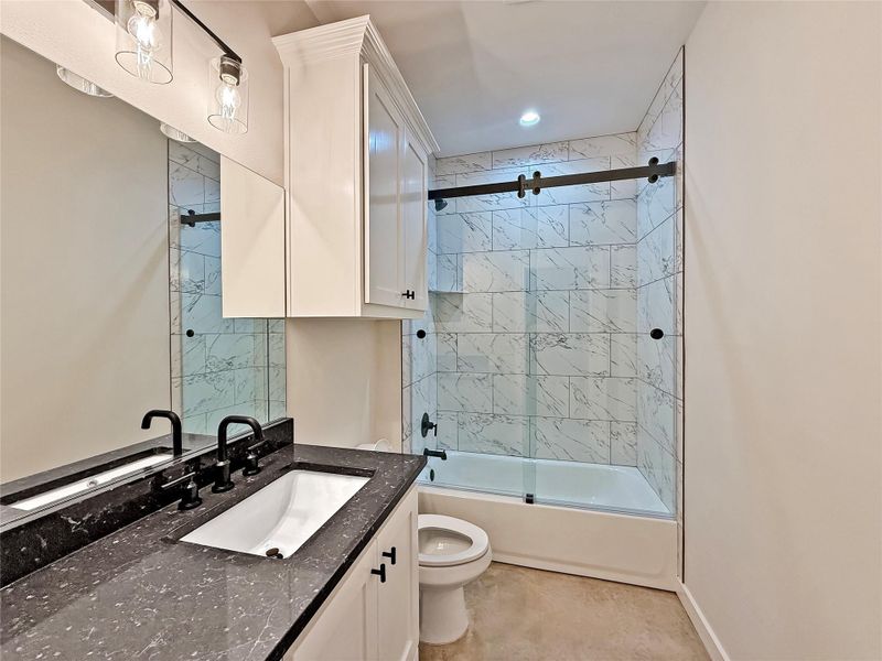 Guest Bathroom with shower / bath combination with glass door and vanity