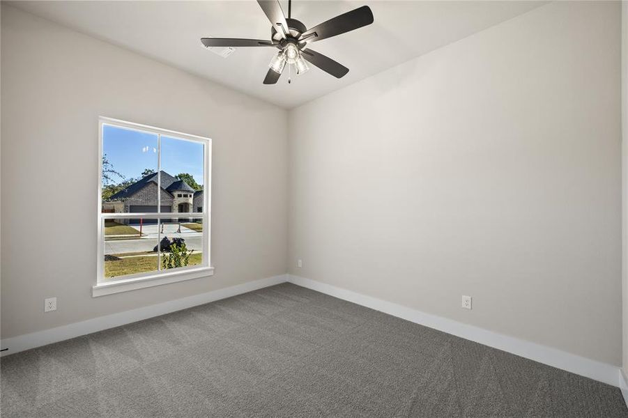 Spare room with carpet and ceiling fan