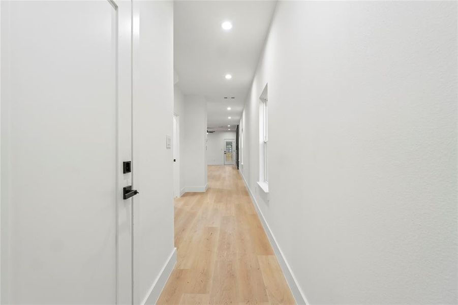 Hall featuring recessed lighting and light wood finished floors Hall featuring recessed lighting and light wood finished floors