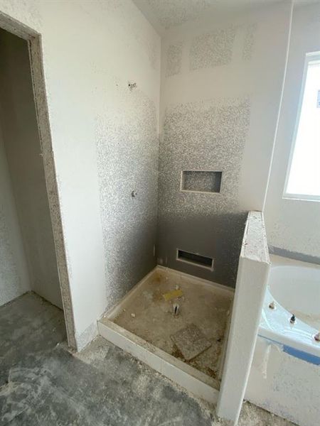 Walk-in shower enclosure with a recessed shelf and a linear drain