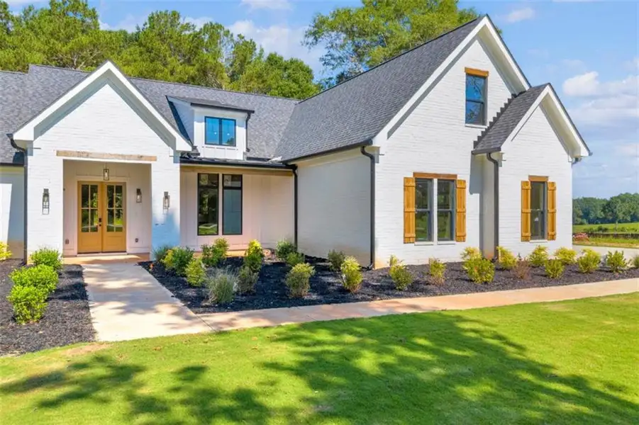 Front exterior of a new home in , Covington, GA, highlighting curb appeal (Image 31). Front exterior of a new home in , Covington, GA, highlighting curb appeal (Image 31).
