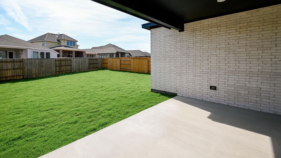 Fenced backyard featuring a patio and a residential view