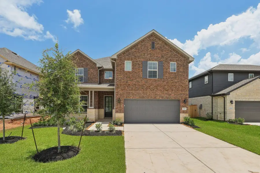Front exterior of a new home in Kingdom Heights, Rosenberg, TX, highlighting curb appeal (Image 2).