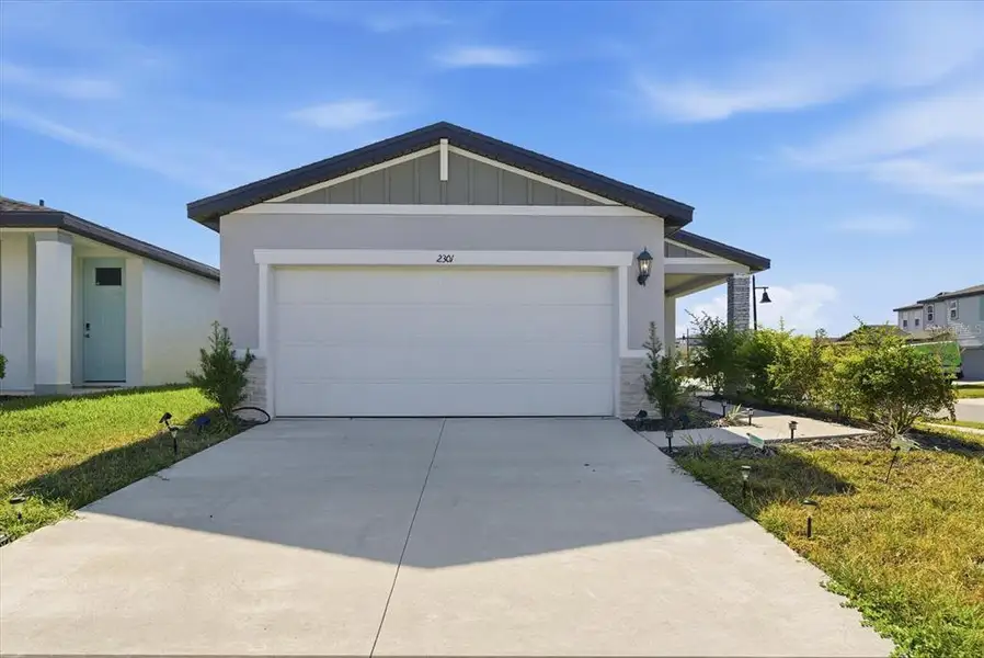 Front exterior of a new home in Park East, Plant City, FL, highlighting curb appeal (Image 2). Front exterior of a new home in Park East, Plant City, FL, highlighting curb appeal (Image 2).