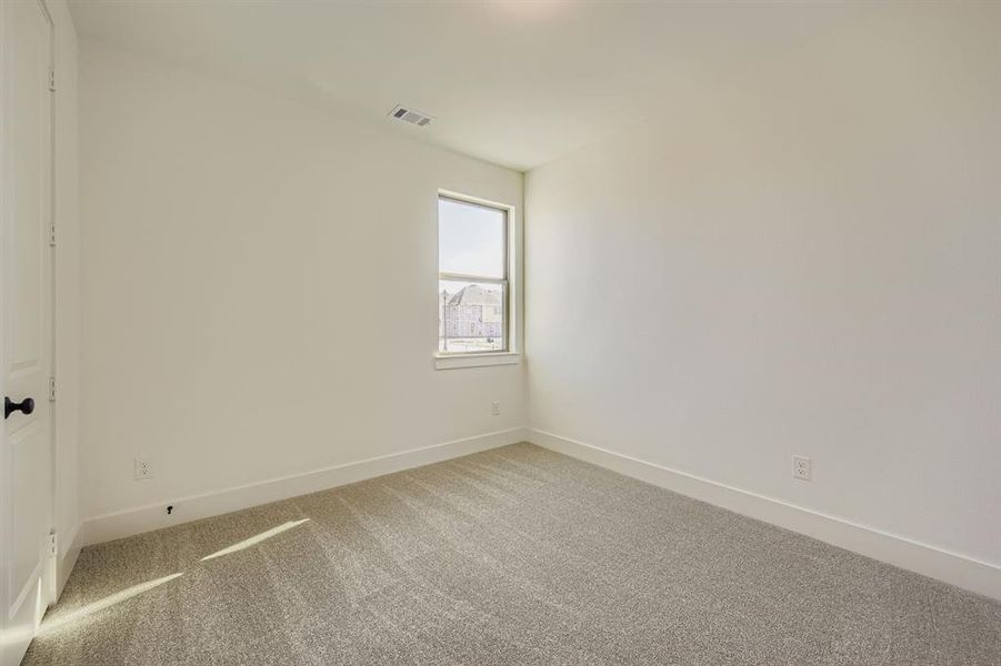 Spare room with carpet floors and baseboards
