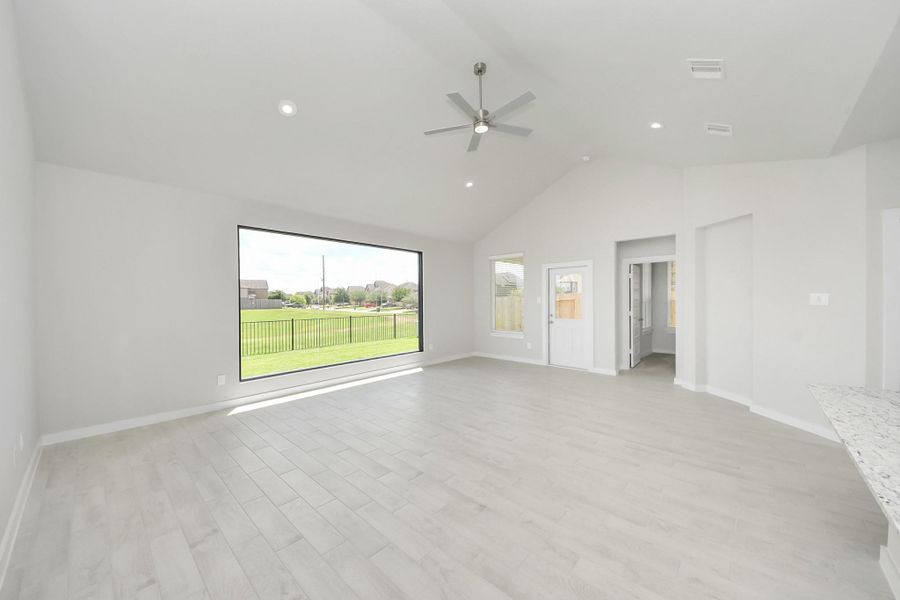 Welcome family and guests to your charming living room! With its high ceilings, recessed lighting, ceiling fan, custom paint, beautiful flooring, and large windows that let in abundant natural light, this room is perfect for gatherings. Welcome family and guests to your charming living room! With its high ceilings, recessed lighting, ceiling fan, custom paint, beautiful flooring, and large windows that let in abundant natural light, this room is perfect for gatherings.