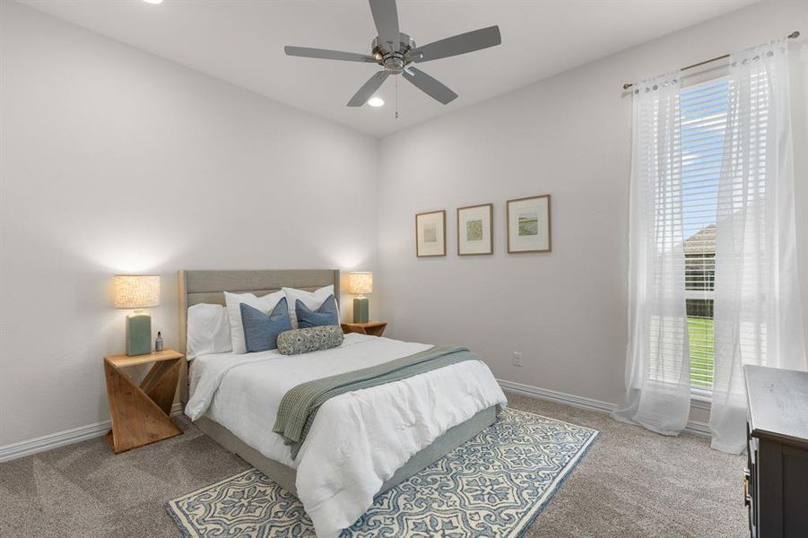 Bedroom with light colored carpet, a ceiling fan, and recessed lighting Bedroom with light colored carpet, a ceiling fan, and recessed lighting