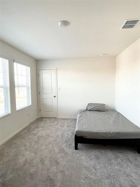 Bedroom featuring baseboards and carpet
