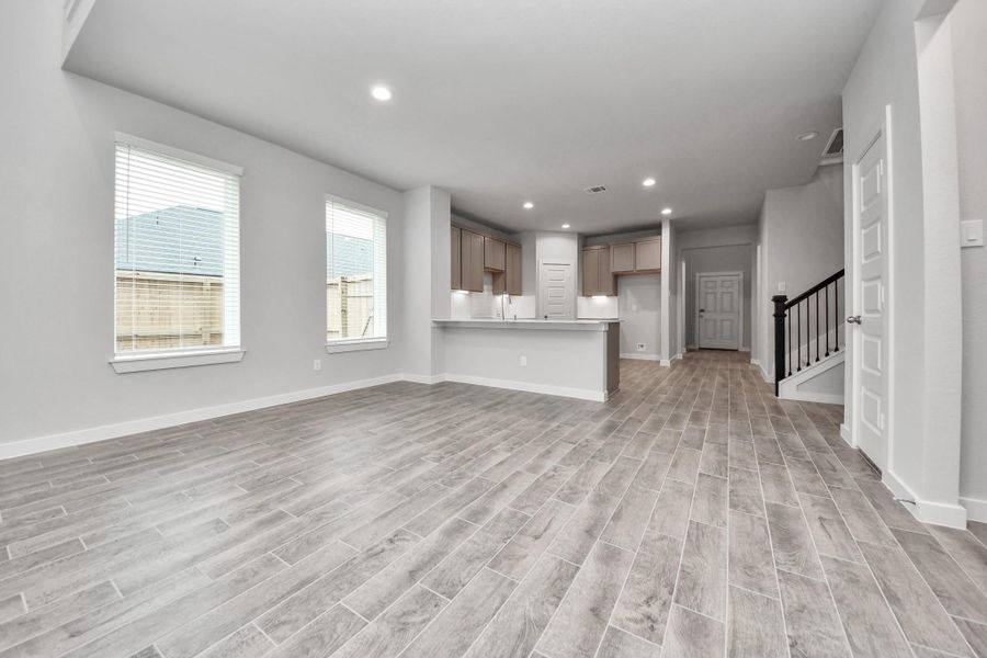Come and unwind after a long day in this magnificent primary suite! This spacious room features plush carpet, warm paint, high ceilings and large windows with privacy blinds. Sample photo of completed home with similar floor plan. Actual colors and selections may vary.