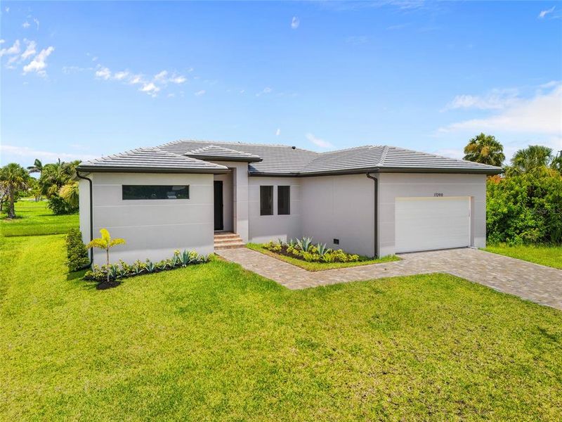 Front exterior of a new home in , Punta Gorda, FL, highlighting curb appeal (Image 28).