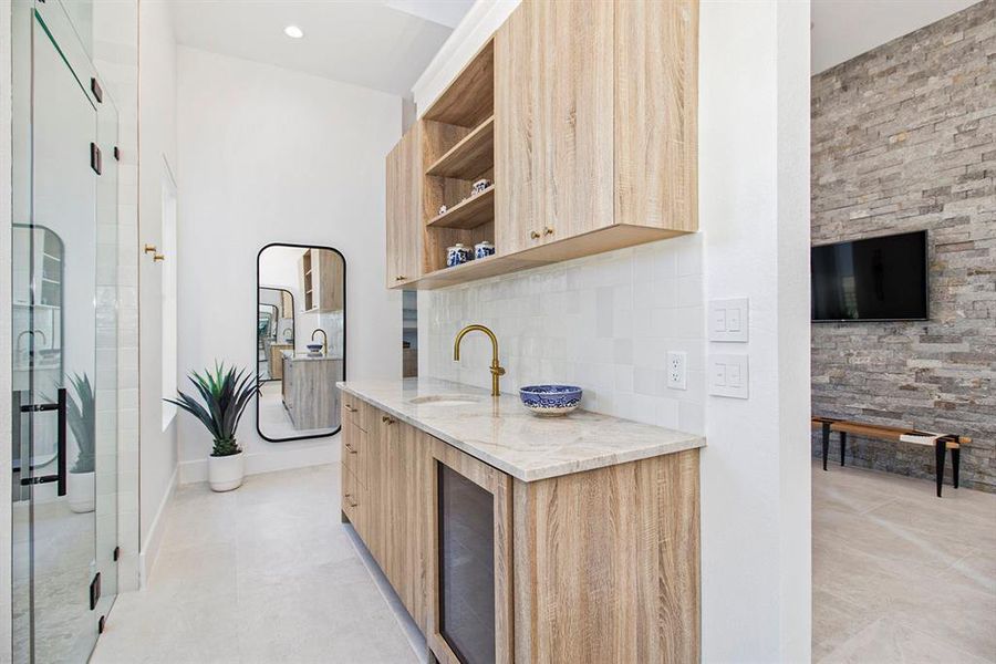 Coffee bar with UC fridge and cabinet space in this primary en suite.