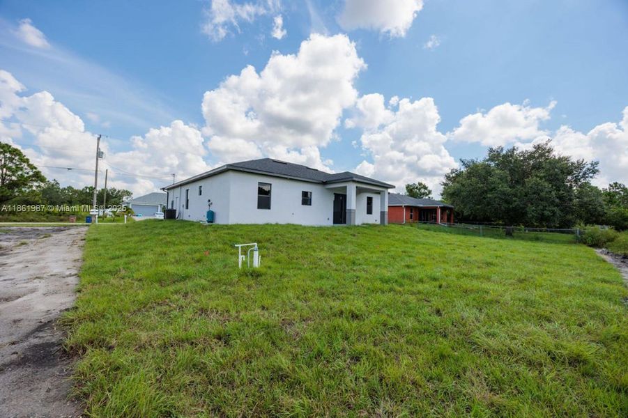 Front exterior of a new home in , Lehigh Acres, FL, highlighting curb appeal (Image 19). Front exterior of a new home in , Lehigh Acres, FL, highlighting curb appeal (Image 19).