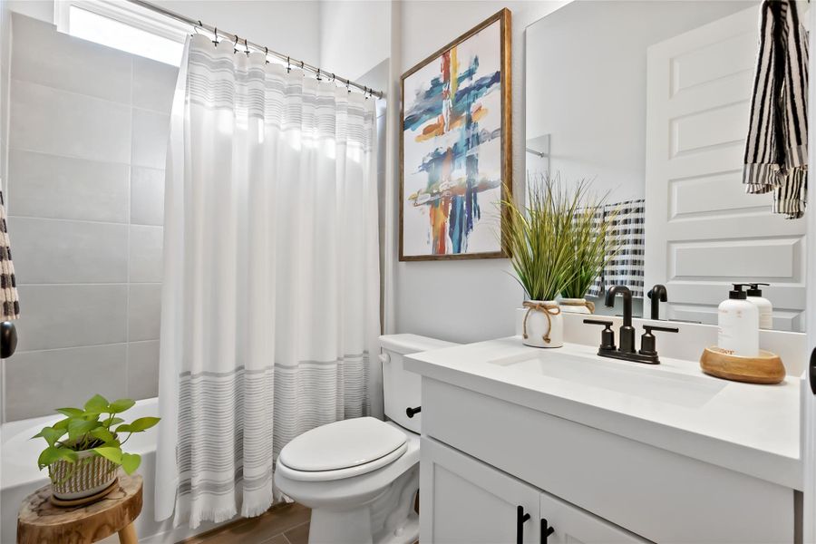 Full bath featuring vanity and shower / tub combo