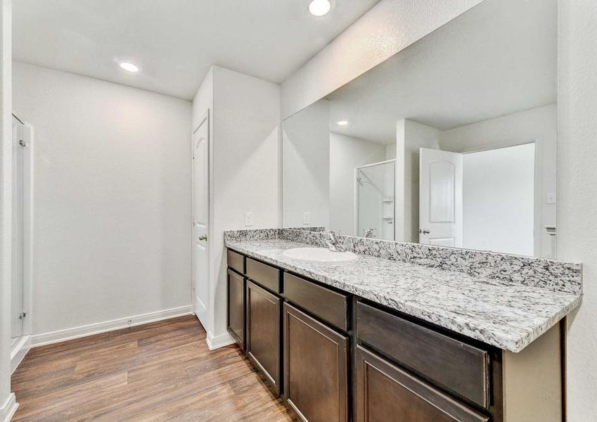 Rio bathroom with granite countertops, extended glass mirror, and white fixtures