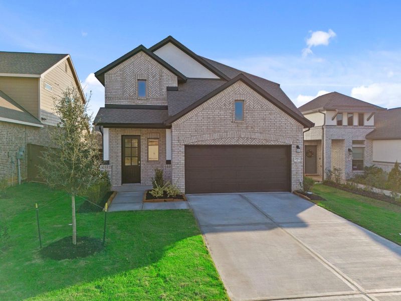Front exterior of a new home in The Trails, New Caney, TX, highlighting curb appeal (Image 19).