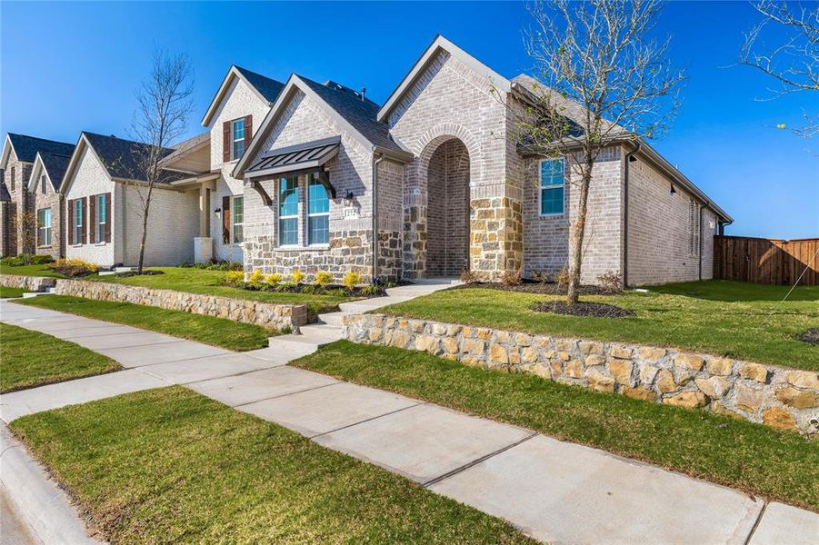 Front exterior of a new home in Edgewater, Fate, TX, highlighting curb appeal (Image 17).