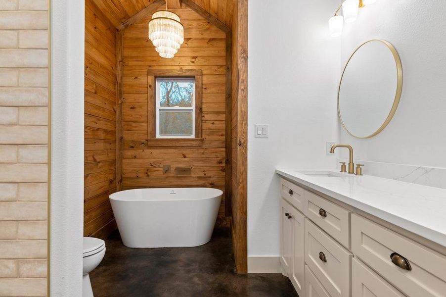 Primary Bathroom with Double Vanity, tiled shower and Freestanding Tub.