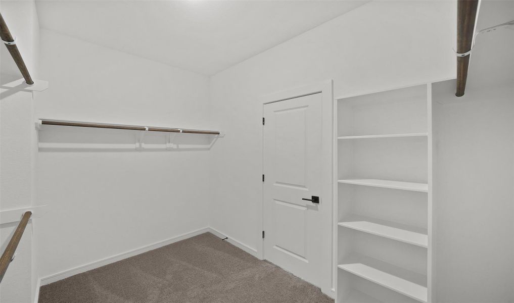 Walk-in closet in primary suite (*Photo not of actual home and used for illustration purposes only.) Walk-in closet in primary suite (*Photo not of actual home and used for illustration purposes only.)