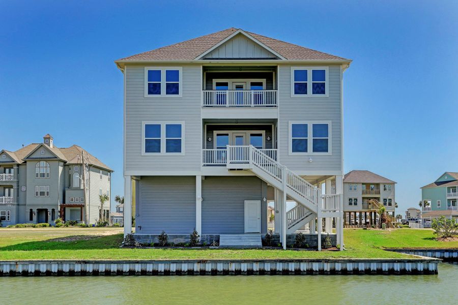 Dual waterfront balconies, the top balcony is connected to the gameroom and the first level is your entry way into the home accessing the living room & kitchen. Dual waterfront balconies, the top balcony is connected to the gameroom and the first level is your entry way into the home accessing the living room & kitchen.