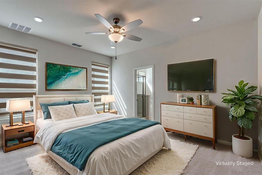 Bedroom featuring light colored carpet, recessed lighting, ceiling fan, and ensuite bath Bedroom featuring light colored carpet, recessed lighting, ceiling fan, and ensuite bath