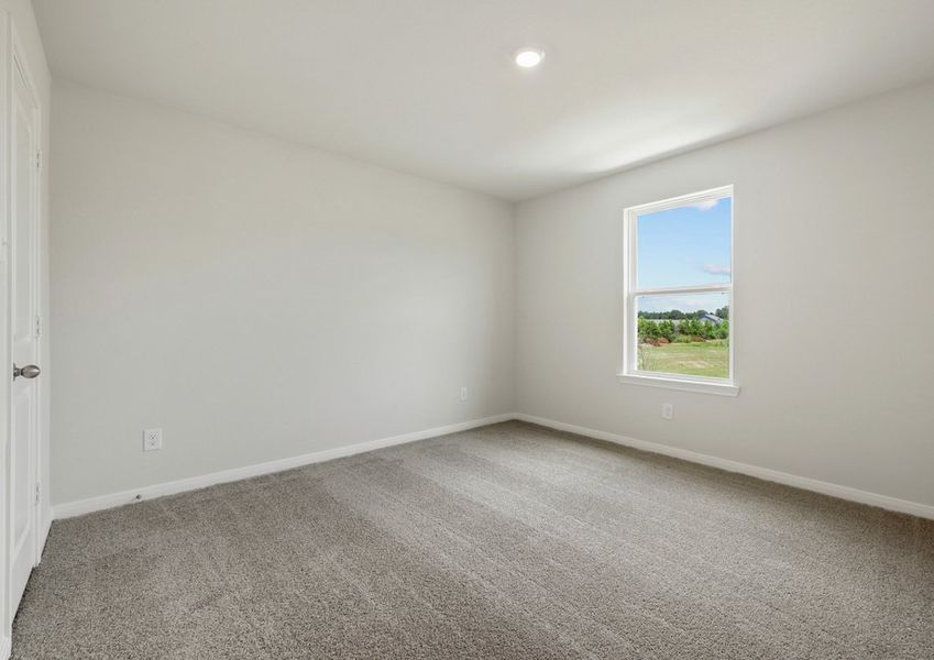 Secondary bedroom with carpet flooring
