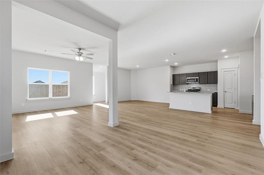 Unfurnished living room featuring light wood-style floors, recessed lighting, and a ceiling fan