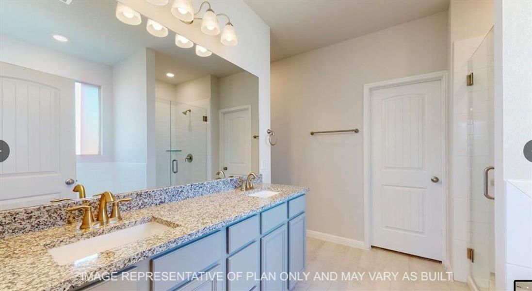 Full bath featuring double vanity, wood finished floors, a shower stall, and a sink Full bath featuring double vanity, wood finished floors, a shower stall, and a sink