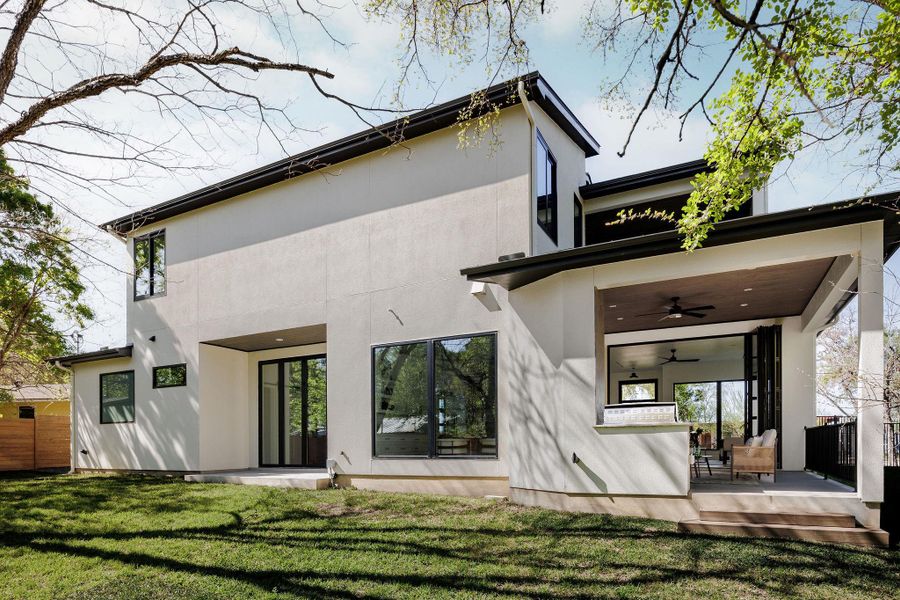 The covered patio offers a shaded retreat with seamless access to the interior living spaces. The rear exterior showcases the home’s architectural presence, set against a backdrop of mature trees and greenbelt. Ask the agent about an approved pool concept. The covered patio offers a shaded retreat with seamless access to the interior living spaces. The rear exterior showcases the home’s architectural presence, set against a backdrop of mature trees and greenbelt. Ask the agent about an approved pool concept.