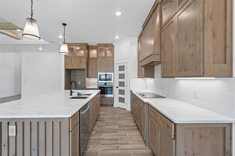 Kitchen with decorative backsplash, wood tiled floors, black appliances, recessed lighting, and premium range hood Kitchen with decorative backsplash, wood tiled floors, black appliances, recessed lighting, and premium range hood