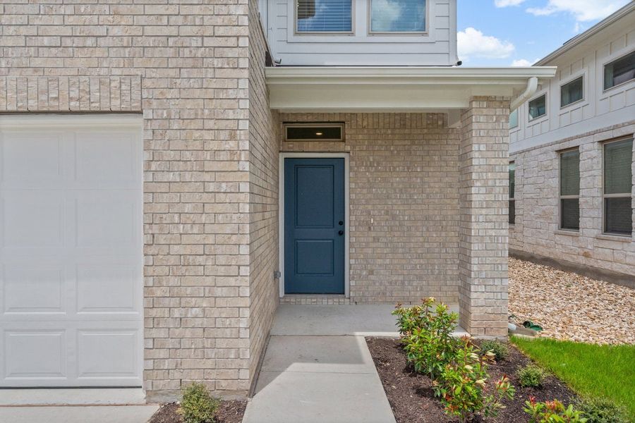 Front exterior of a new home in Crosswinds, Kyle, TX, highlighting curb appeal (Image 19).