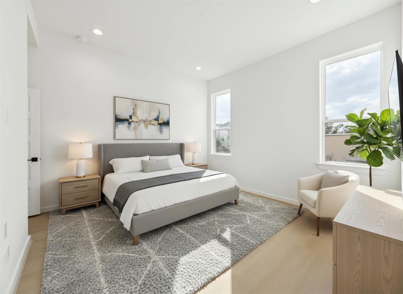 Another view of the primary bedroom showcases its warm tones, soaring ceilings, and natural light, emphasizing the serene and luxurious retreat-like atmosphere. *Virtually staged*