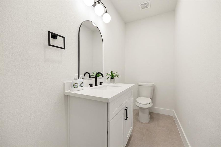 Elegant Secondary BathroomThis beautifully designed bathroom features a sleek vanity with quartz countertops, black fixtures, and modern lighting. The neutral tones and stylish finishes create a clean and sophisticated space, perfect for guests or everyday use!