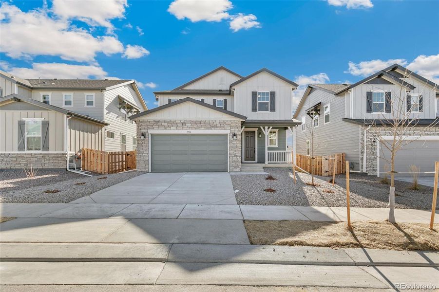 Front exterior of a new home in Turnberry, Commerce City, CO, highlighting curb appeal (Image 22).