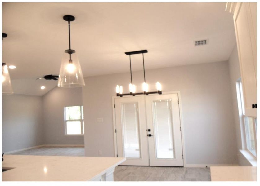 Kitchen featuring french doors and pendant lighting