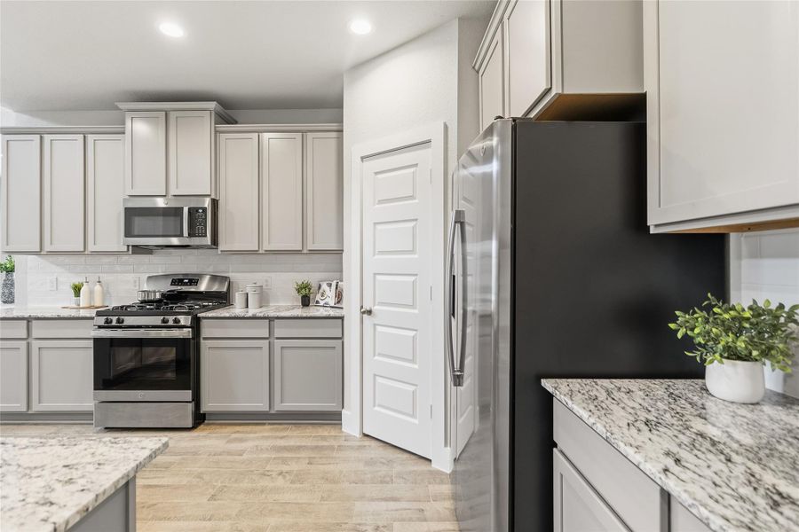 Featuring granite countertops, abundant cabinetry, stainless steel appliances, and a generous pantry, your kitchen is designed for both everyday living and effortless entertaining.