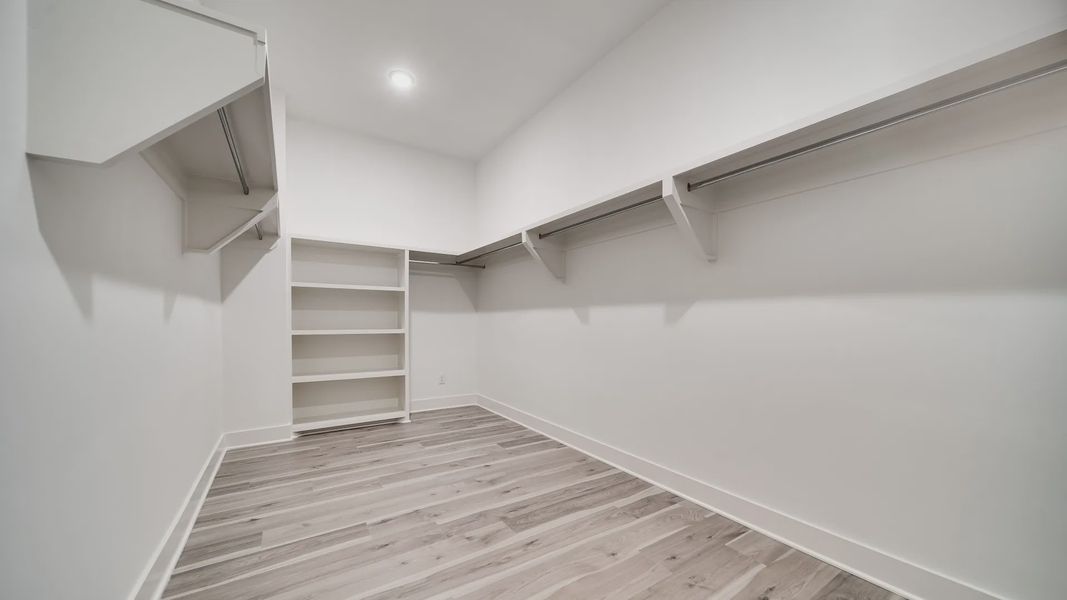 Large walk-in closet showing built-in shelving