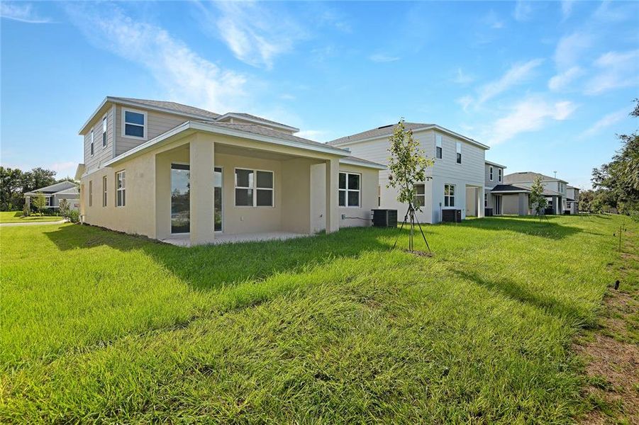 Front exterior of a new home in Seasons at Shores of Lake Dell, Dundee, FL, highlighting curb appeal (Image 1).