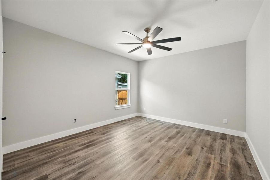 Spare room with wood finished floors and a ceiling fan Spare room with wood finished floors and a ceiling fan