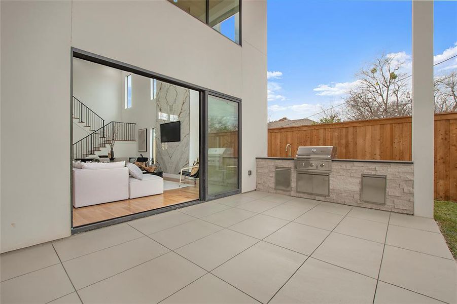 View of patio / terrace with a grill and an outdoor kitchen