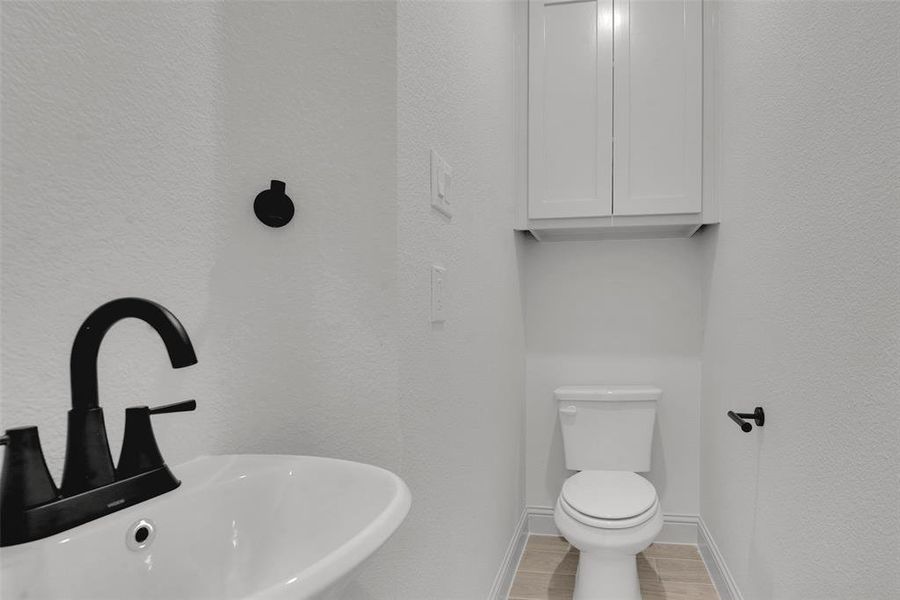 Bathroom with toilet and wood finished floors Bathroom with toilet and wood finished floors