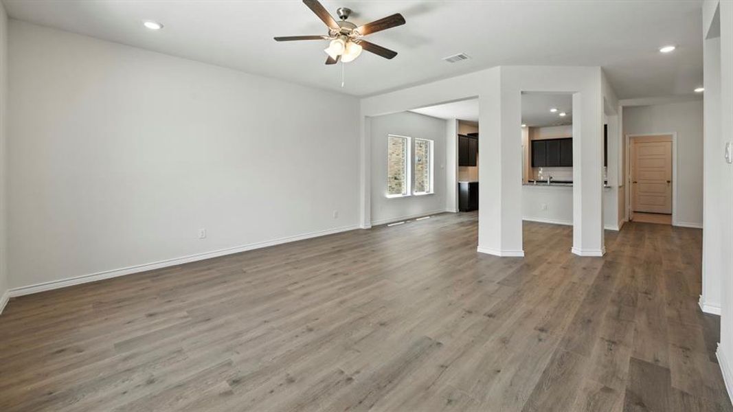 Unfurnished living room with recessed lighting, dark wood finished floors, and a ceiling fan