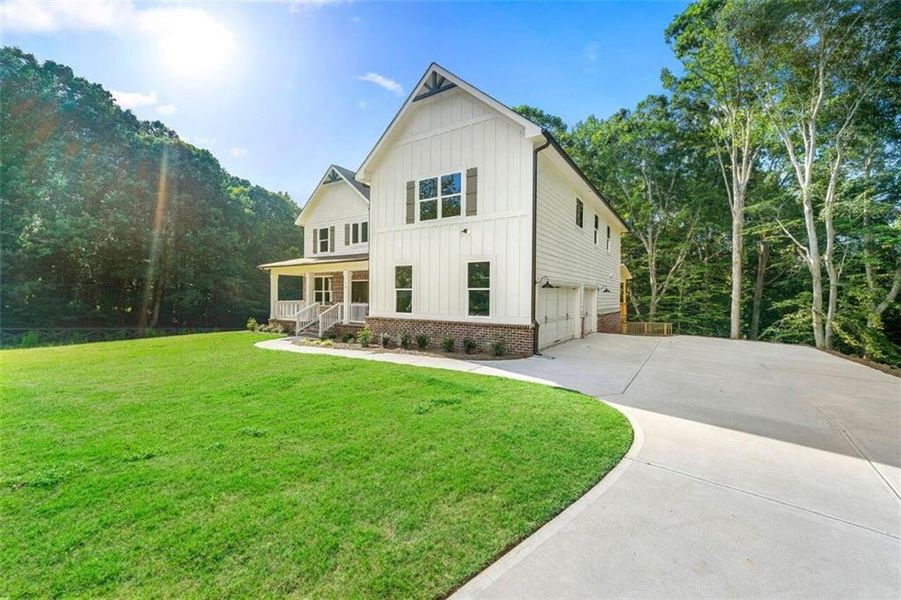 Front exterior of a new home in Steeplechase, Hoschton, GA, highlighting curb appeal (Image 2).